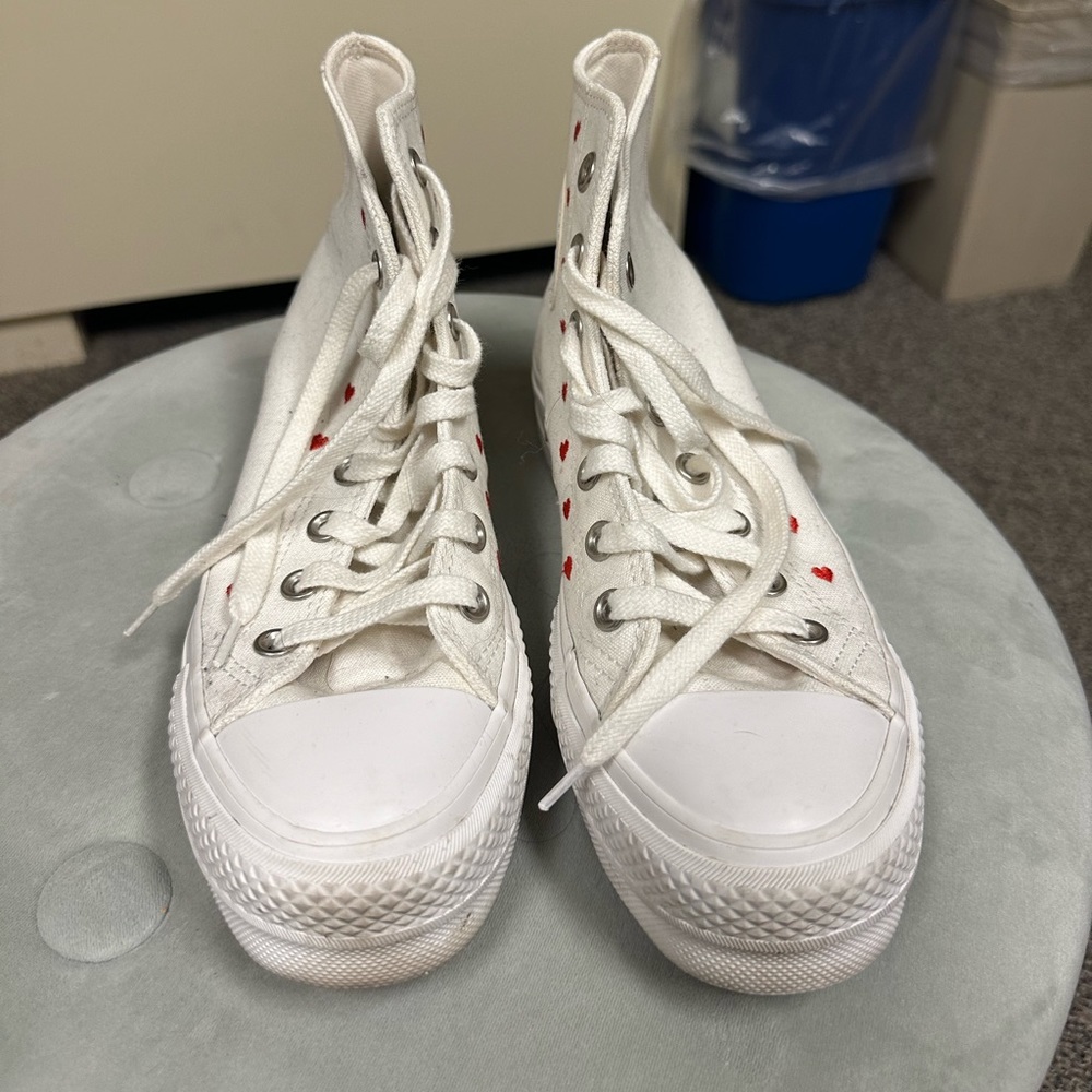 White platform converse with red hearts.